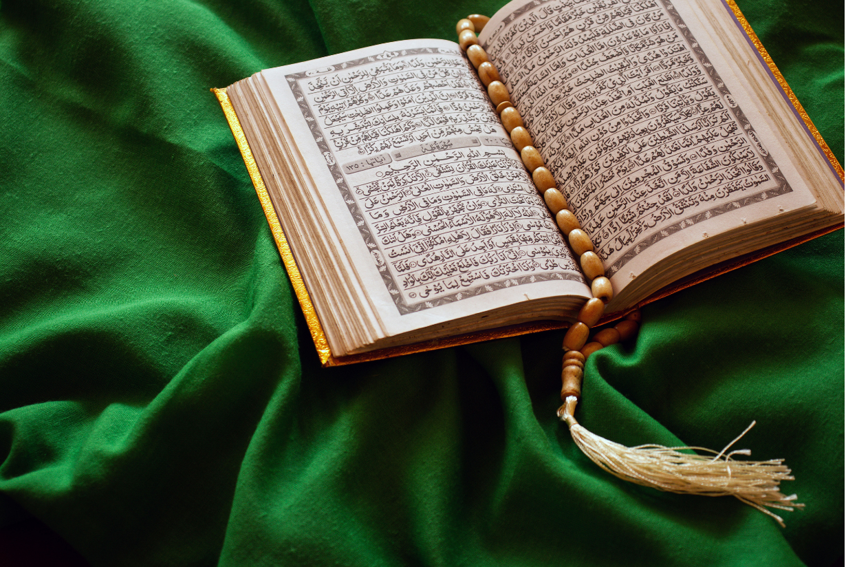 Open Quran on Green Satin in Sunlight